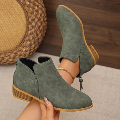 Pointed toe PU leather block heel booties in green.