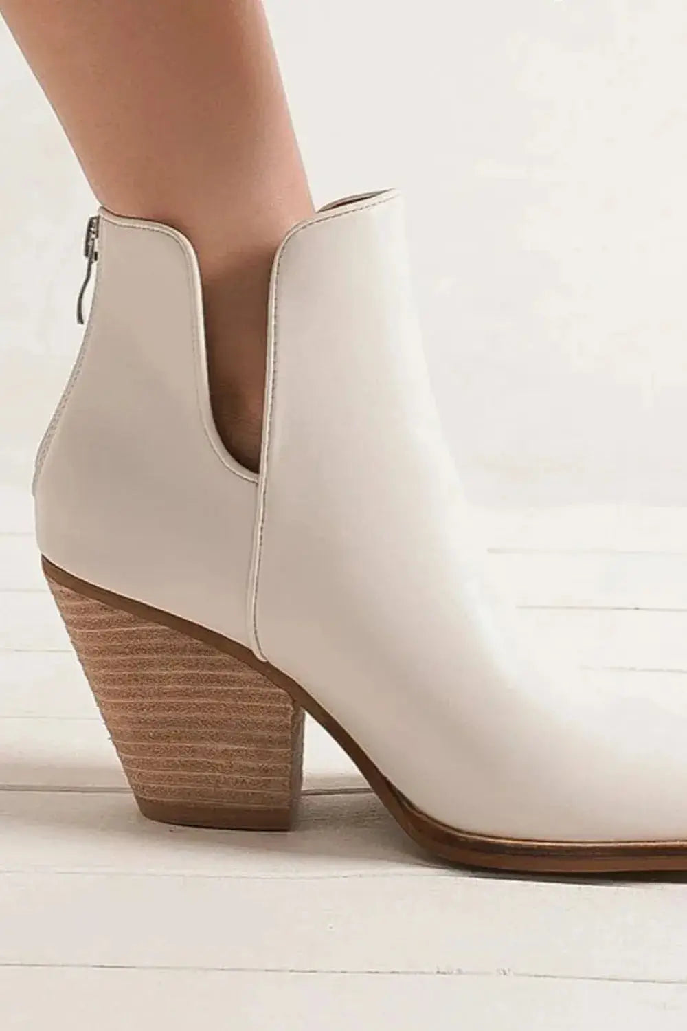 White PU leather ankle boots with a pointed toe and wooden block heel.
