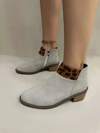 Light grey suede ankle boots with leopard print trim and a low block heel.