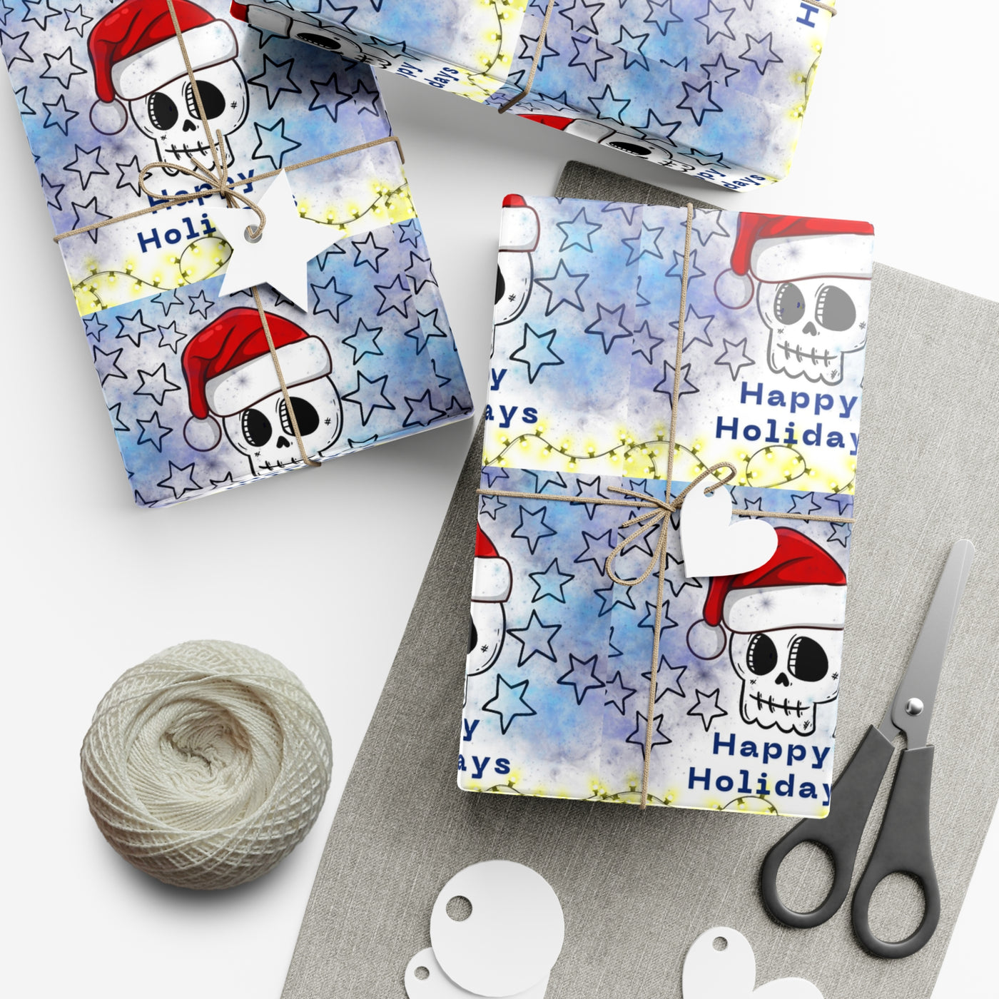 Gift wrap paper with a skull wearing a Santa hat and stars design.