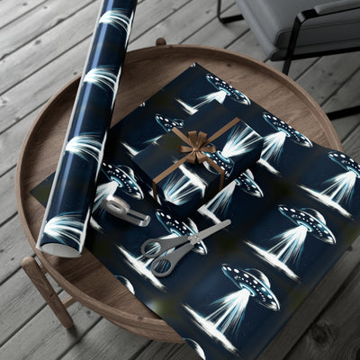Wrapping paper with a dark blue background featuring a repeating pattern of flying saucers emitting bright beams of light.