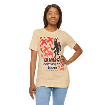 A woman wears a tan t-shirt with a Krampus graphic and text.