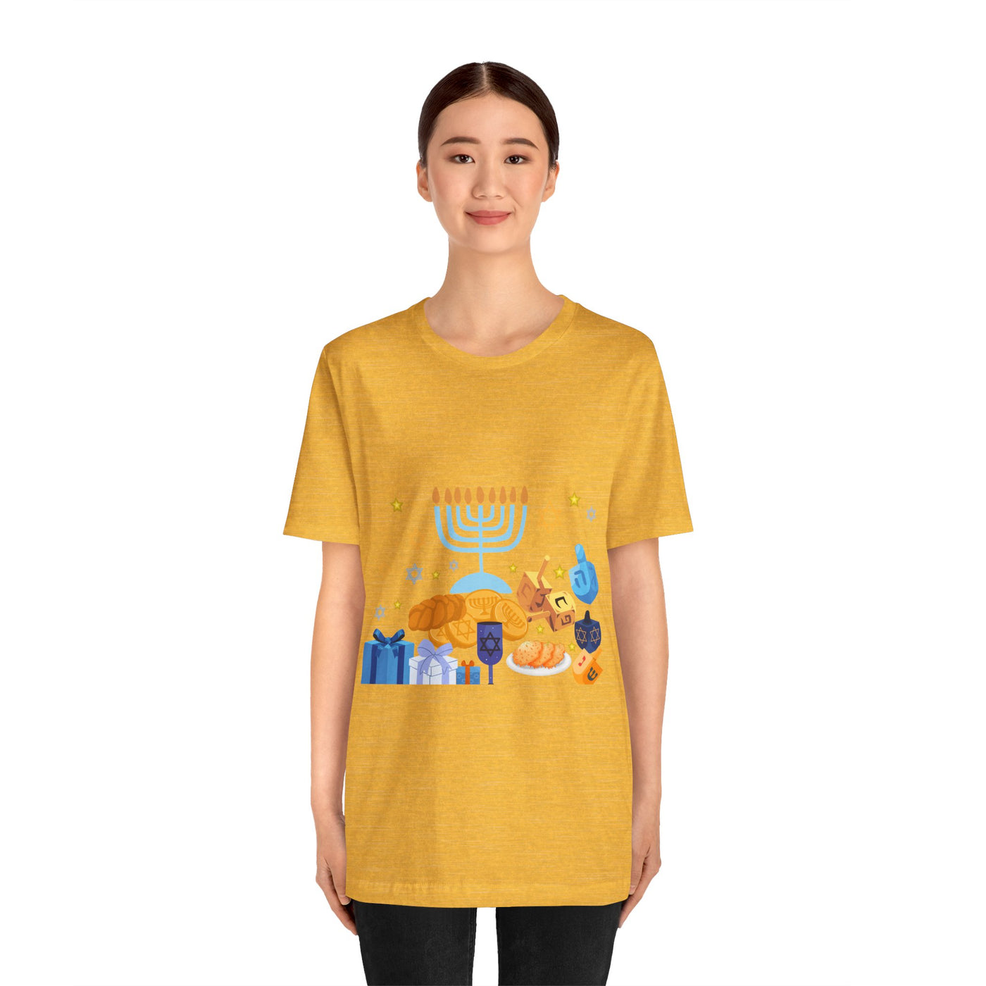 Yellow t-shirt with a graphic of Hanukkah symbols including a menorah, dreidels, gelt, and gifts.