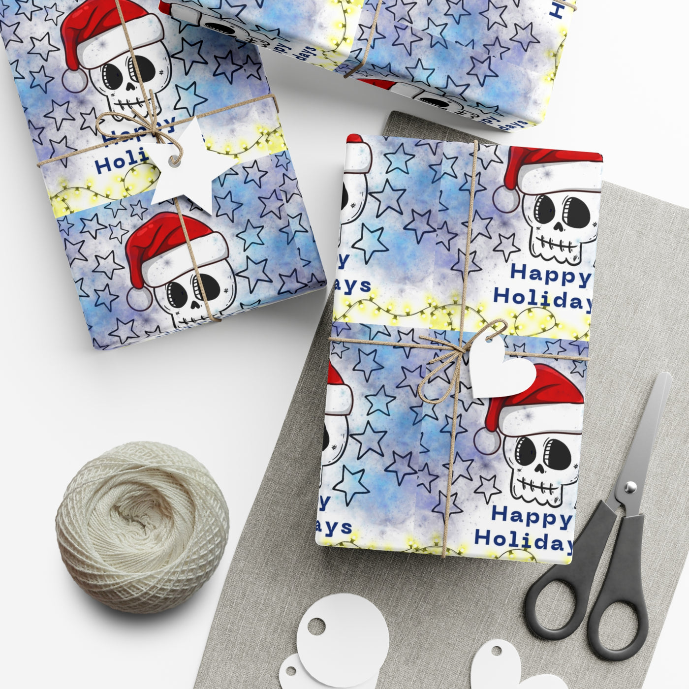 Gift wrap paper with a skull wearing a Santa hat and stars design.