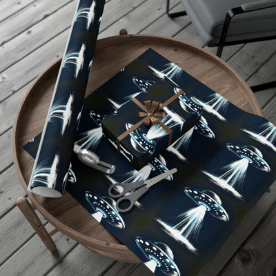 Wrapping paper with a dark blue background featuring a repeating pattern of flying saucers with beams of light.