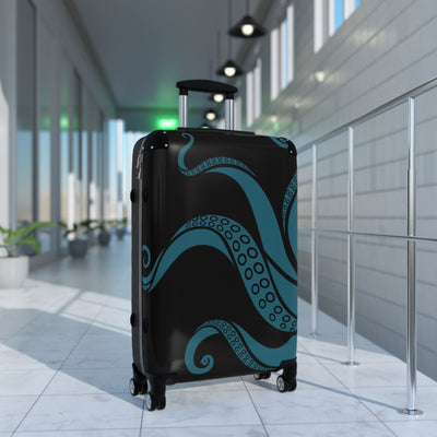 Kraken-themed suitcase with teal tentacles and swivel wheels in bright hallway, perfect for unique travel style.