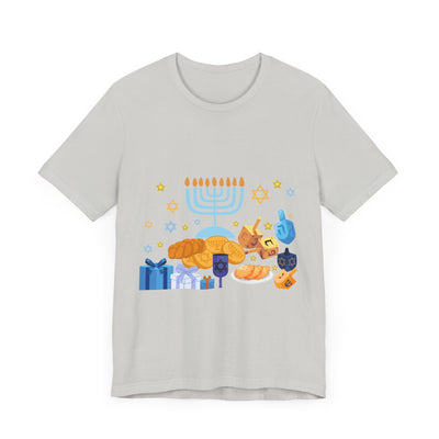 Light grey t-shirt with a colorful Hanukkah graphic featuring a menorah, dreidels, gelt, and gifts.