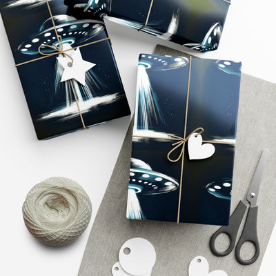 Wrapping paper with a dark blue background featuring a repeating pattern of white and blue UFOs with beams of light.