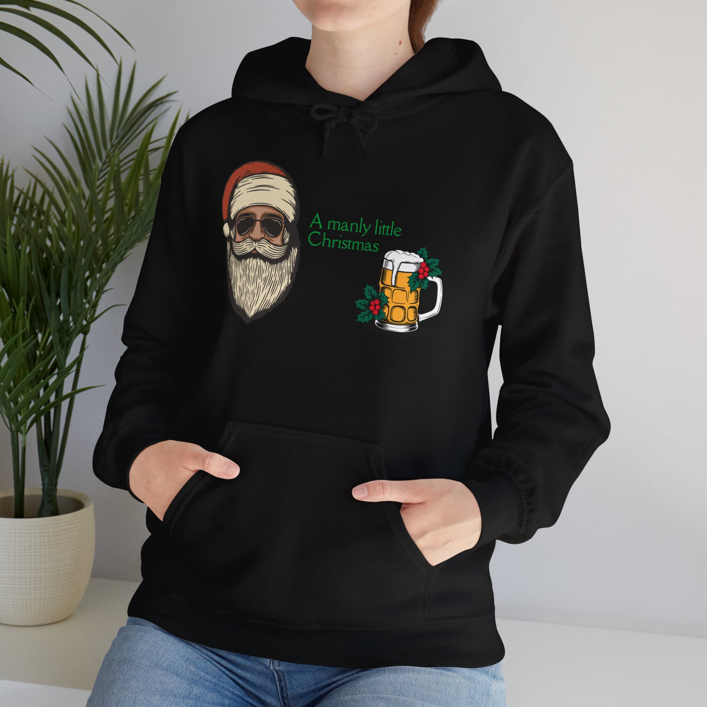 Black hoodie with a graphic of a cool Santa, a beer mug, and the text "A manly little Christmas".