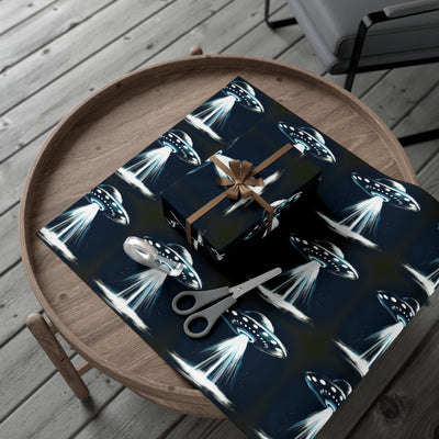 Wrapping paper with a dark blue background featuring a repeating pattern of white UFOs beaming light.