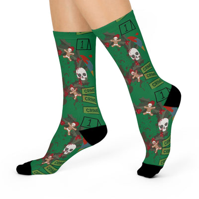 Green crew socks with a true crime wreath design featuring skulls and gingerbread men.