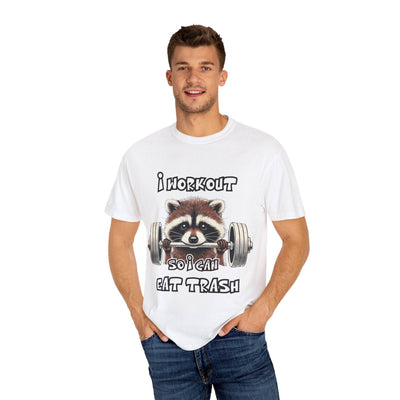 Model wearing a white T-shirt with a raccoon lifting weights and the text 'I Workout So I Can Eat Trash.' Stylish and humorous gym wear.