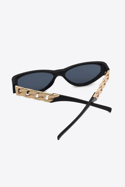 Black cat eye sunglasses with gold chain detail on the temples.