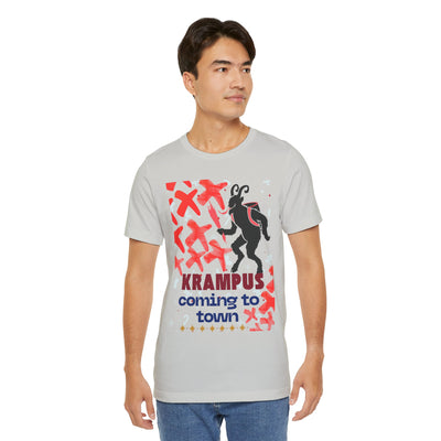A man wears a light gray t-shirt with a Krampus graphic and text.