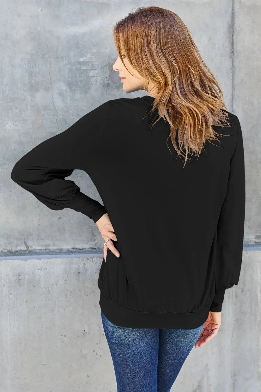 Black v-neck top with lantern sleeves.