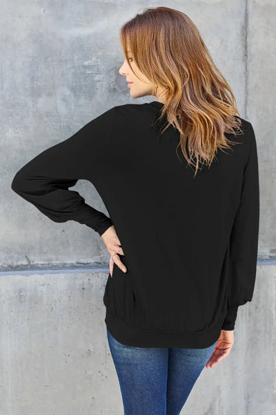 Black v-neck top with lantern sleeves.