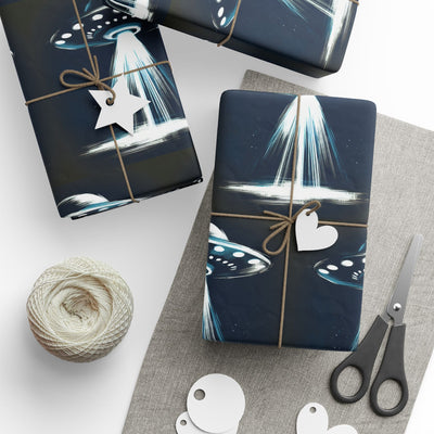 UFO-themed wrapping paper with a beam of light and a star tag.