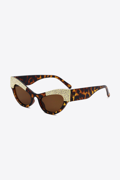 Cat-eye sunglasses with tortoise shell print and rhinestone trim.