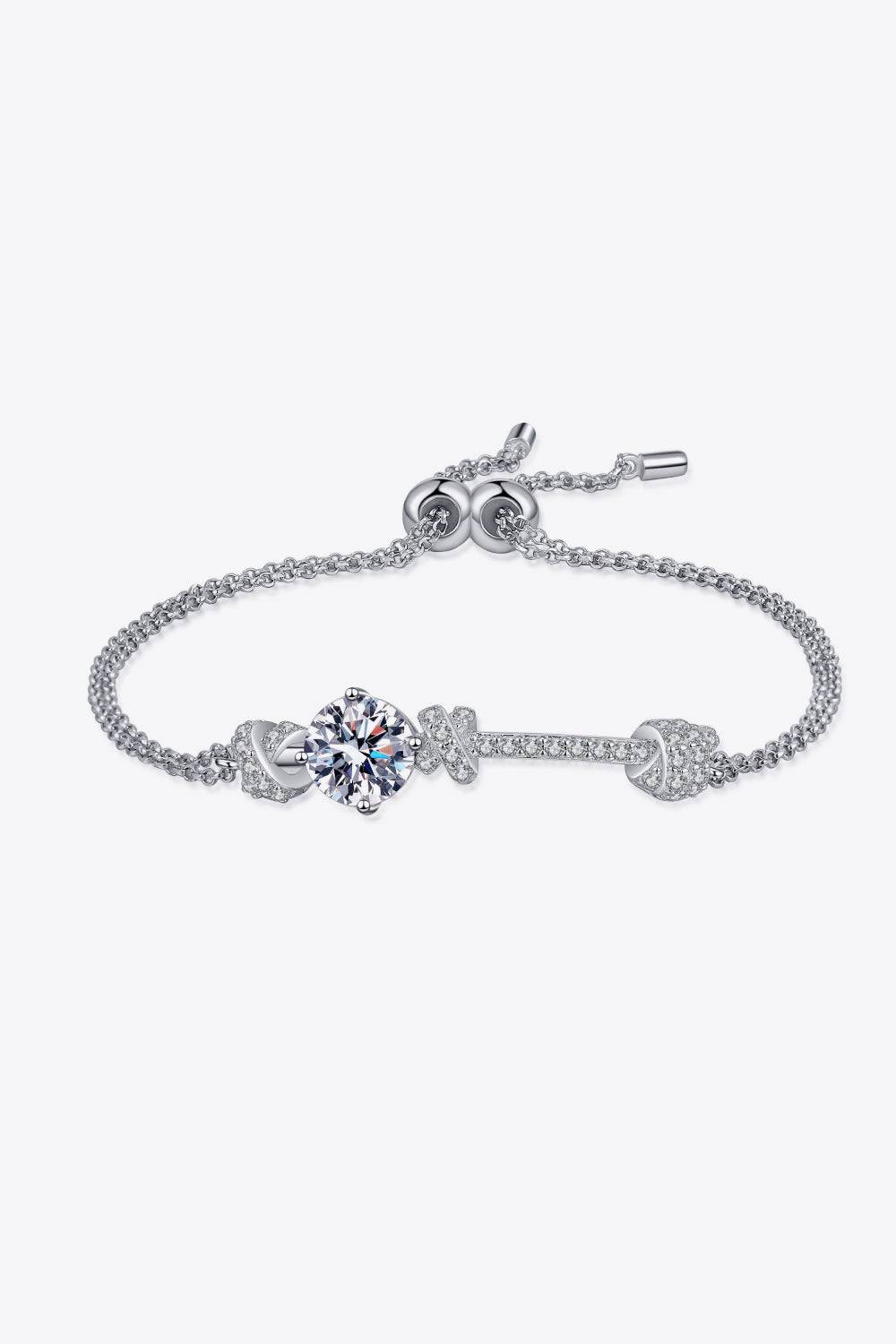 A minimalist sterling silver bracelet with a central 2-carat moissanite stone and cubic zirconia accents.