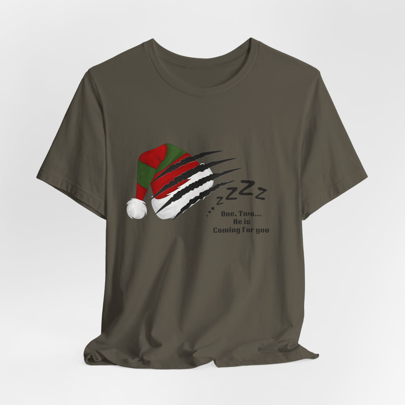 A dark grey t-shirt with a graphic of a clawed hand ripping through a Santa hat and a ball, with "Zzz" and text.