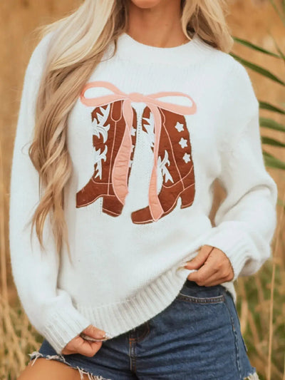 White drop shoulder sweater with embroidered cowboy boots and pink bow detail.