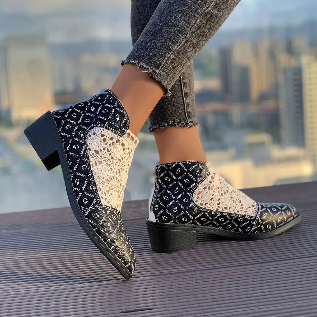 Printed point toe block heel boots with mesh detailing.