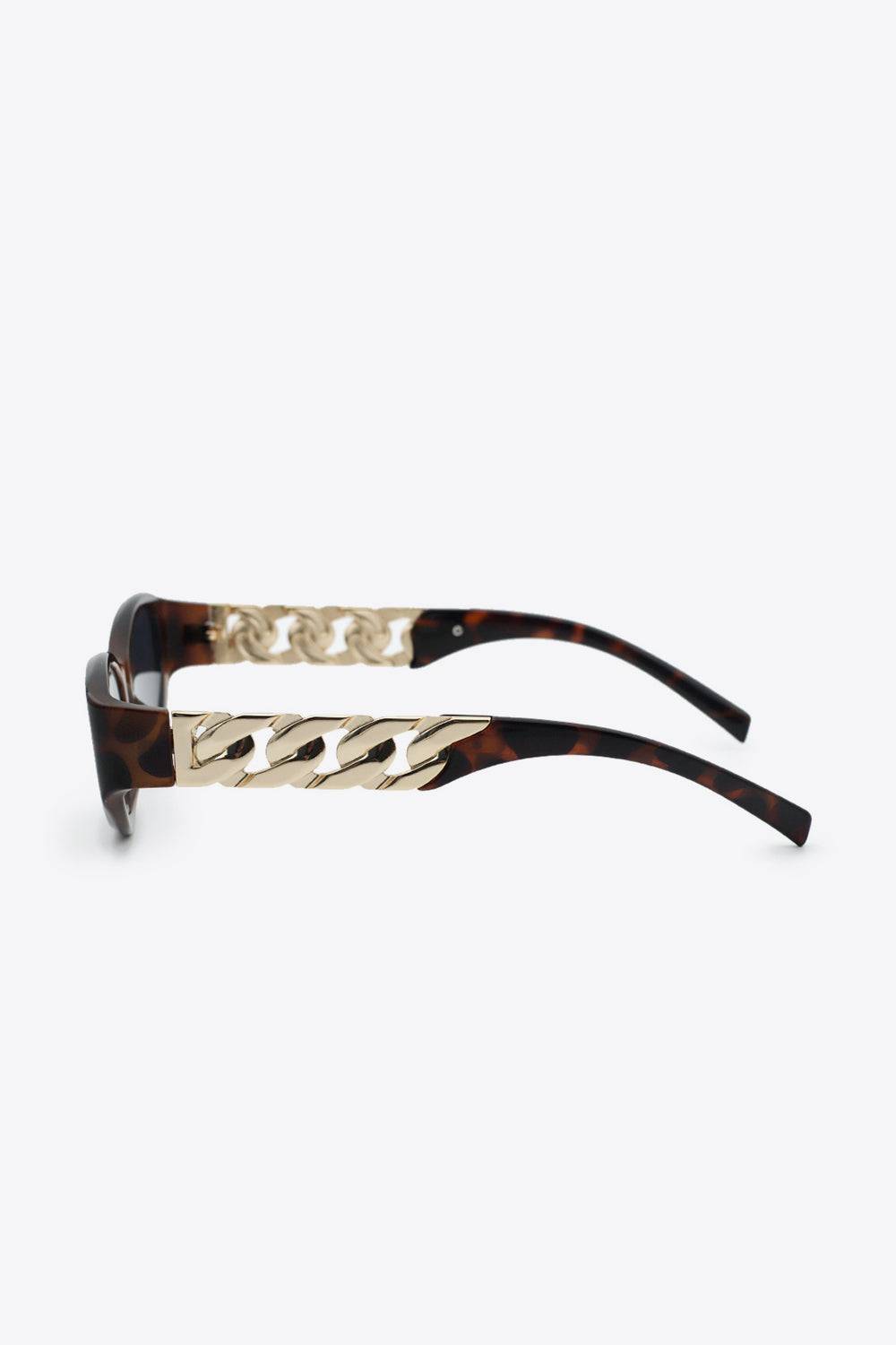Cat eye sunglasses with tortoise shell frames and gold chain detail.