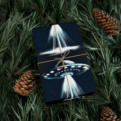 Wrapping paper with a dark blue background featuring a UFO with beams of light and stars.