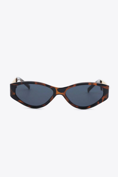 Cat eye sunglasses with tortoise shell frames and chain detail.