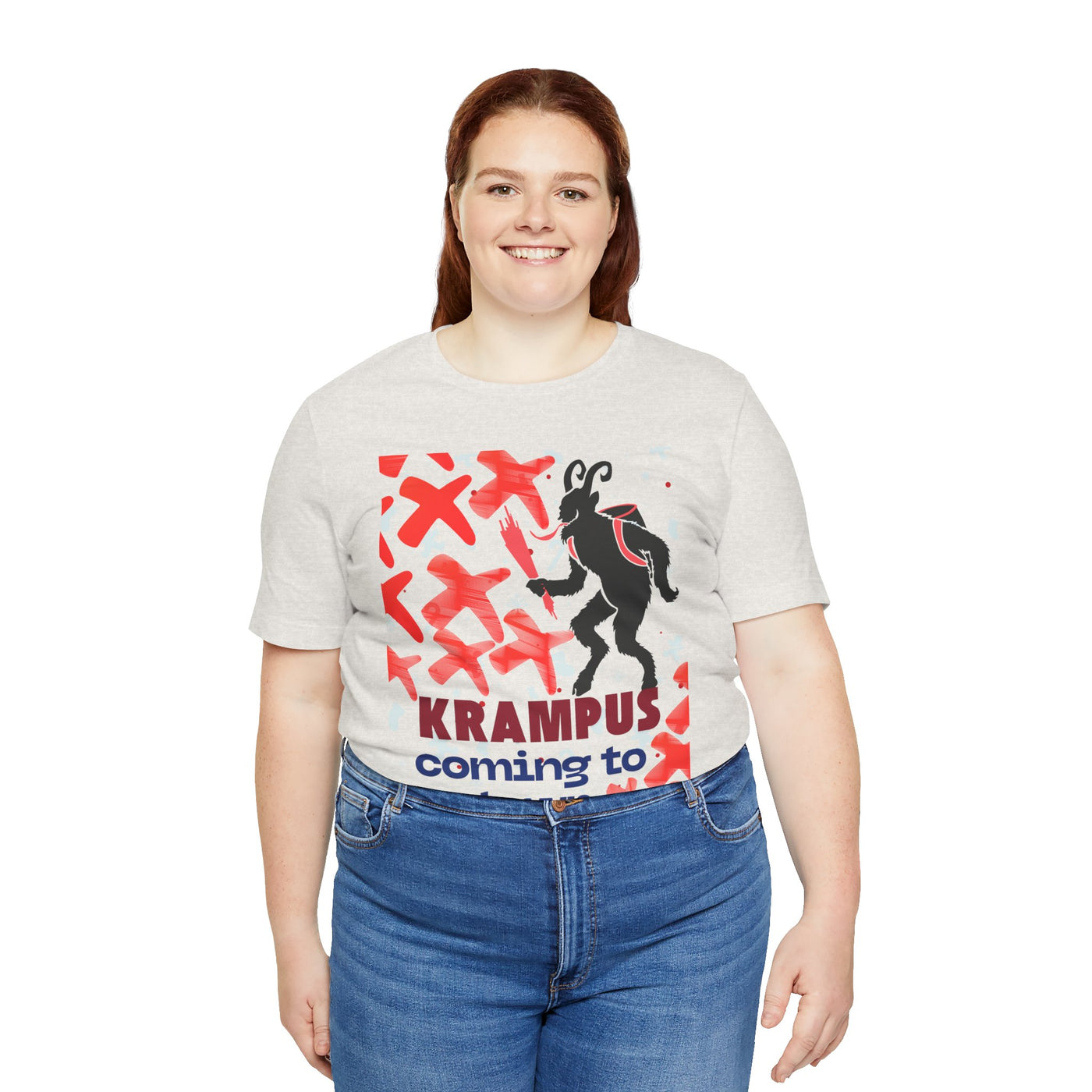 A woman wears a light grey t-shirt with a Krampus graphic and text.