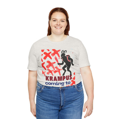 A woman wears a light grey t-shirt with a Krampus graphic and text.