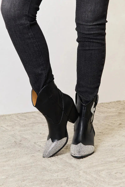 Black ankle boots with pointed toes, chunky heels, and rhinestone embellishments.