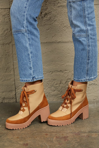 Tan and brown faux leather block heel booties with laces.