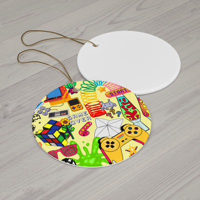 Ceramic ornament with retro 8-bit video game graphics and a gold string.