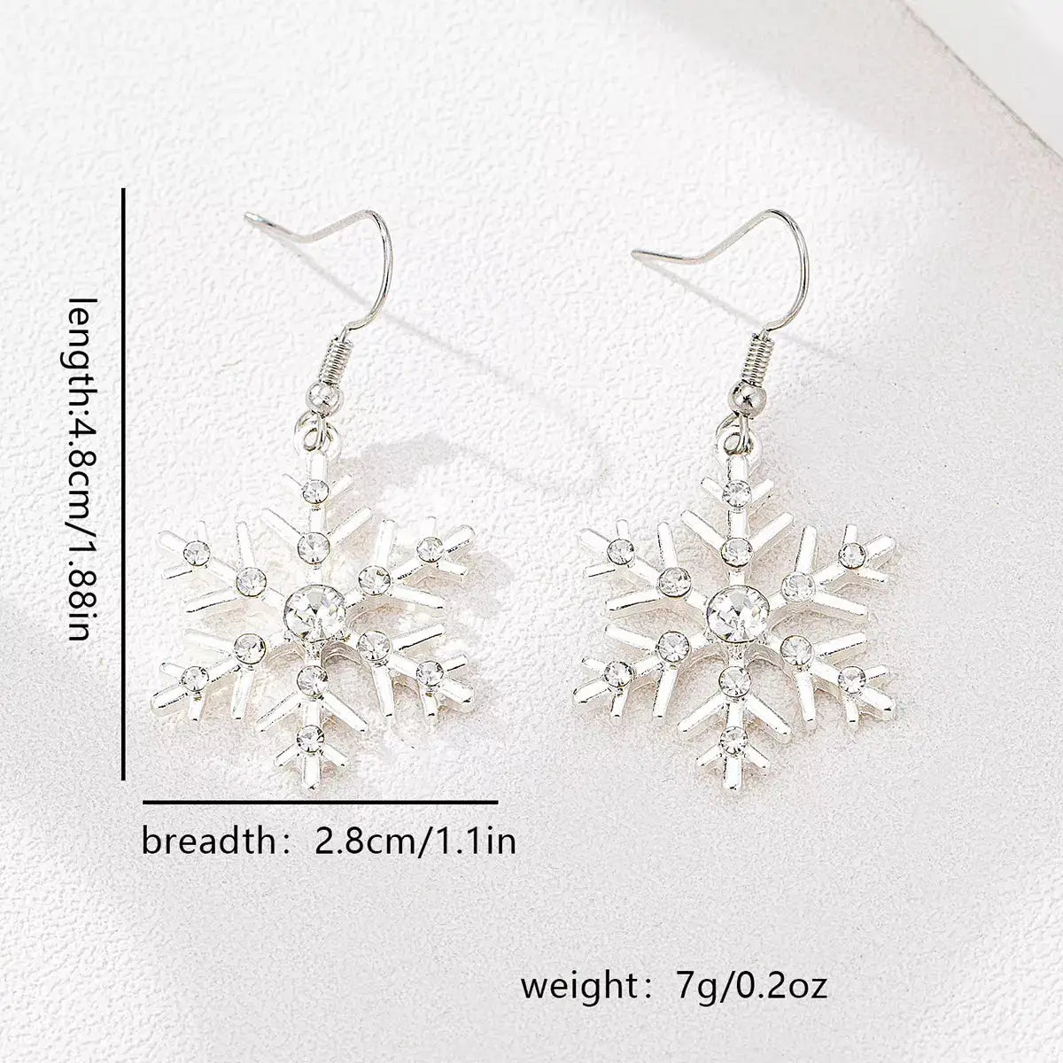 Silver-plated snowflake dangle earrings with rhinestones.