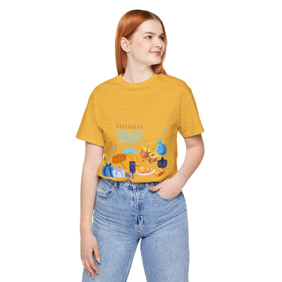 Yellow unisex t-shirt with a Hanukkah graphic featuring a menorah, dreidels, gelt, and gifts.