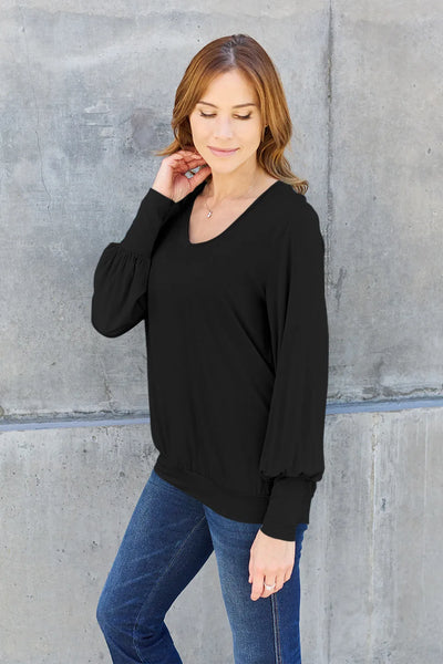 Black v-neck top with lantern sleeves and a cinched hem.