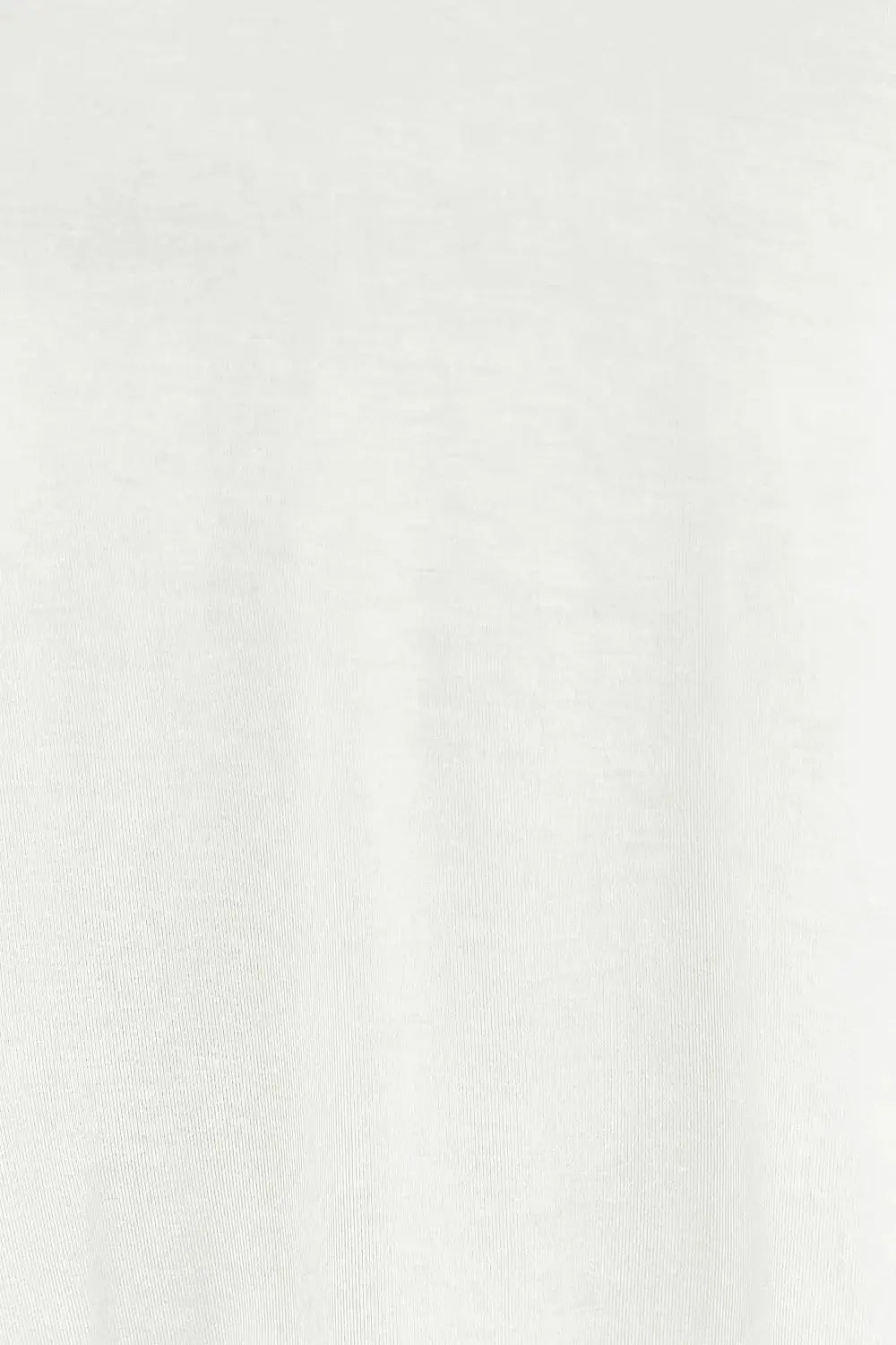 A white v-neck top with lantern sleeves made from a stretchy rayon blend.