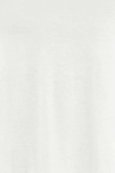 A white v-neck top with lantern sleeves made from a stretchy rayon blend.