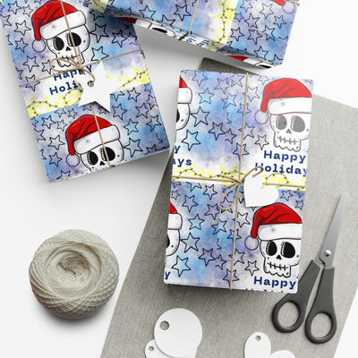 Gift wrap with a blue watercolor background, black stars, and skulls wearing Santa hats.