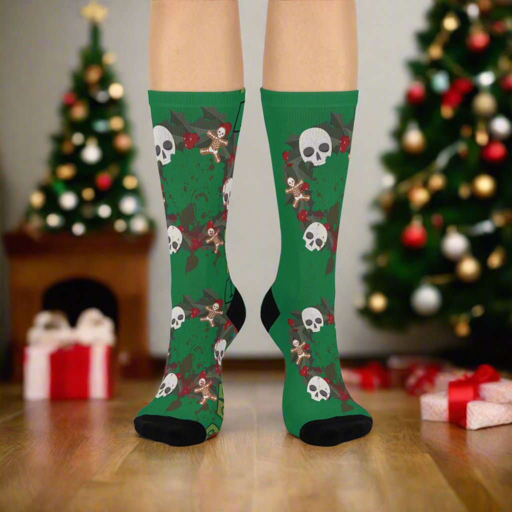 Green crew length socks with a true crime wreath design featuring skulls and gingerbread men.