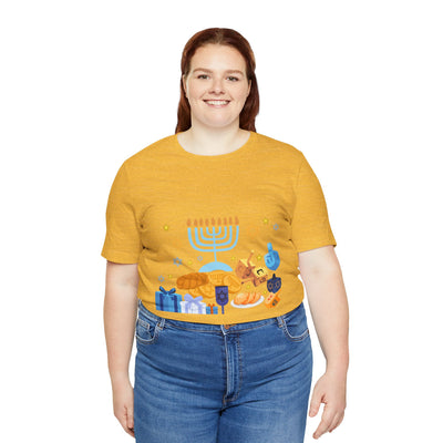 Unisex cotton t-shirt with a Hanukkah graphic featuring a menorah, dreidels, and gifts.