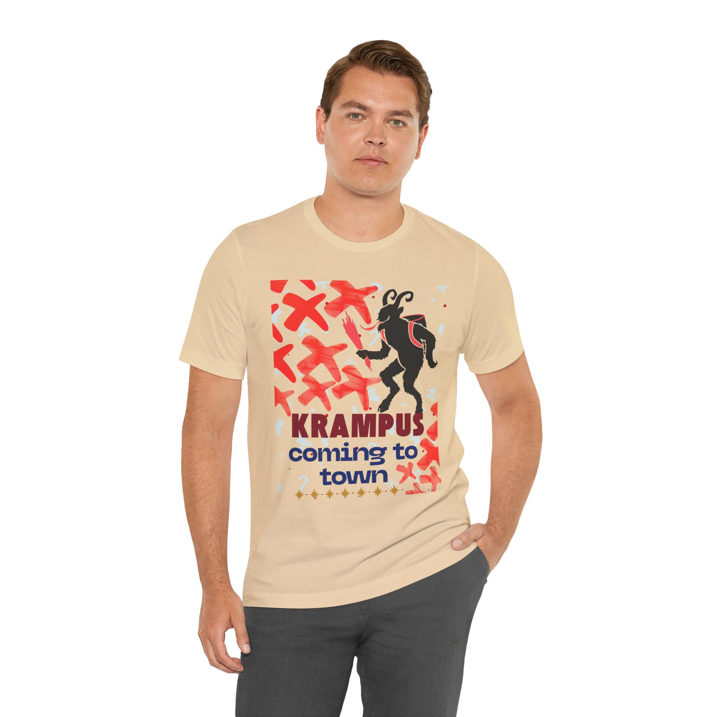 A man wears a tan t-shirt with a graphic of Krampus and the text "Krampus coming to town".
