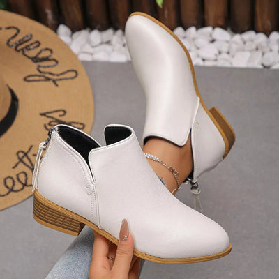 White PU leather pointed toe block heel booties with a side zipper.