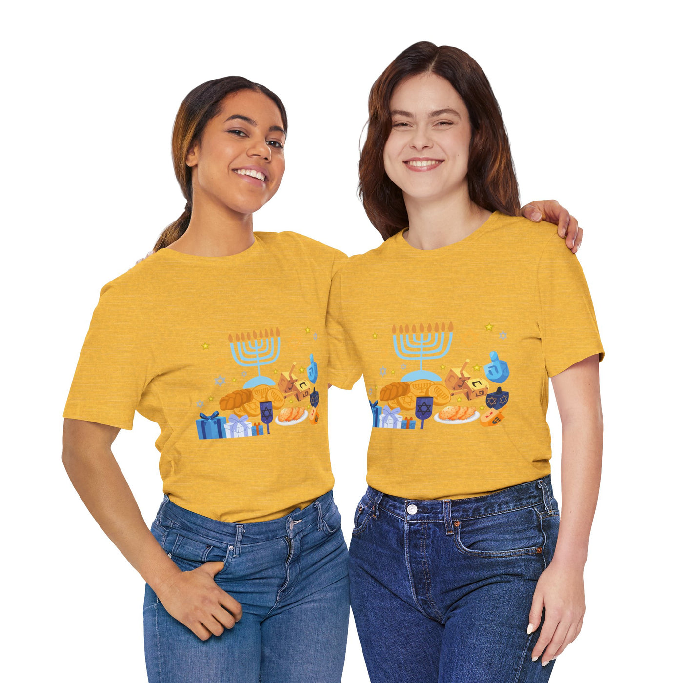 Two women in yellow t-shirts with a Hanukkah graphic stand with arms around each other.