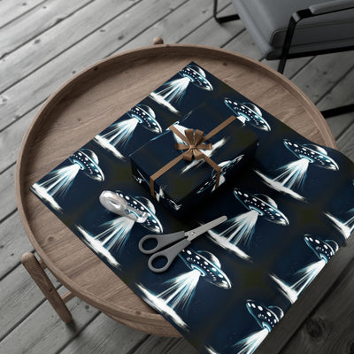 Wrapping paper with a dark blue background featuring a repeating pattern of white and blue UFOs emitting beams of light.