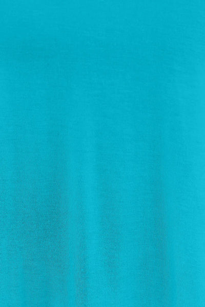 A close-up of a turquoise blue stretchy rayon blend fabric.