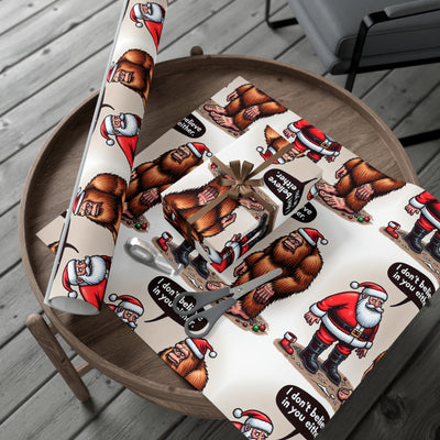 Wrapping paper with Santa and Bigfoot designs, on a wooden table.