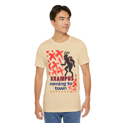 A man wears a tan t-shirt with a Krampus graphic and text.