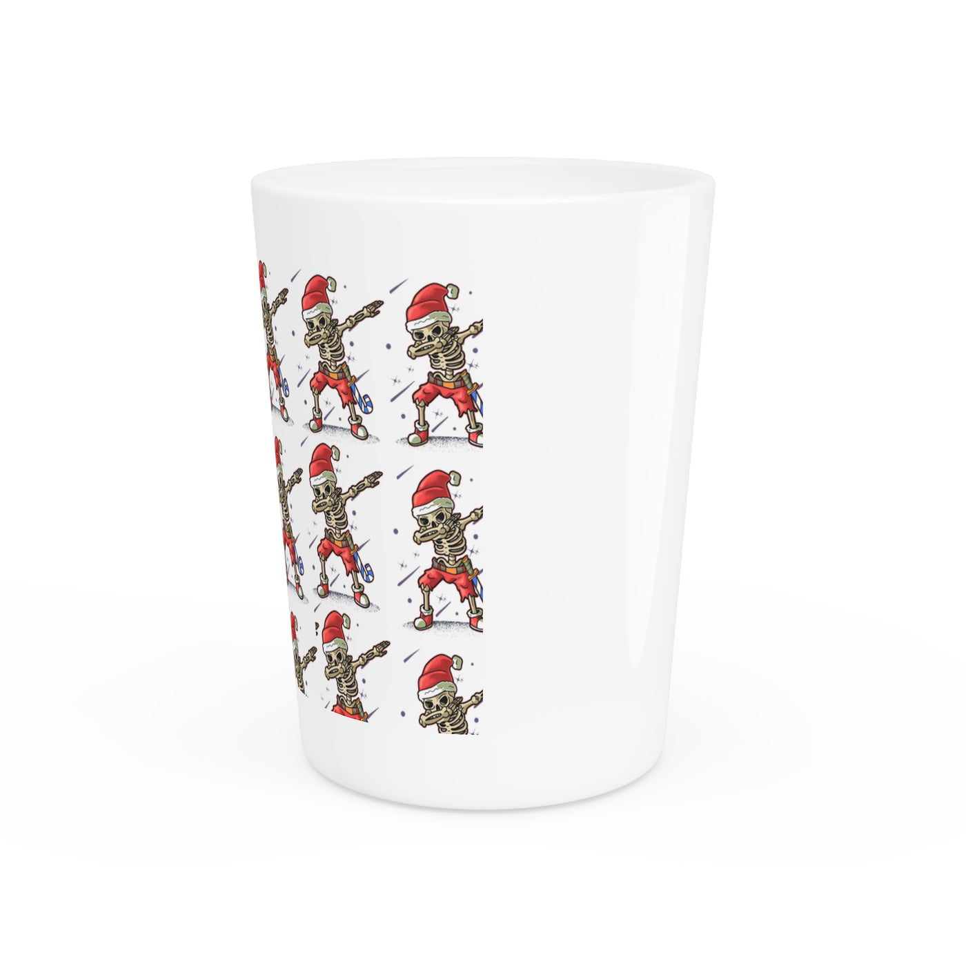 Ceramic shot glass with a repeating pattern of skeletons wearing Santa hats.